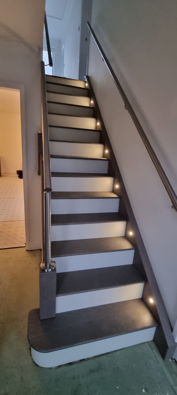 Warm recessed lights along a staircase